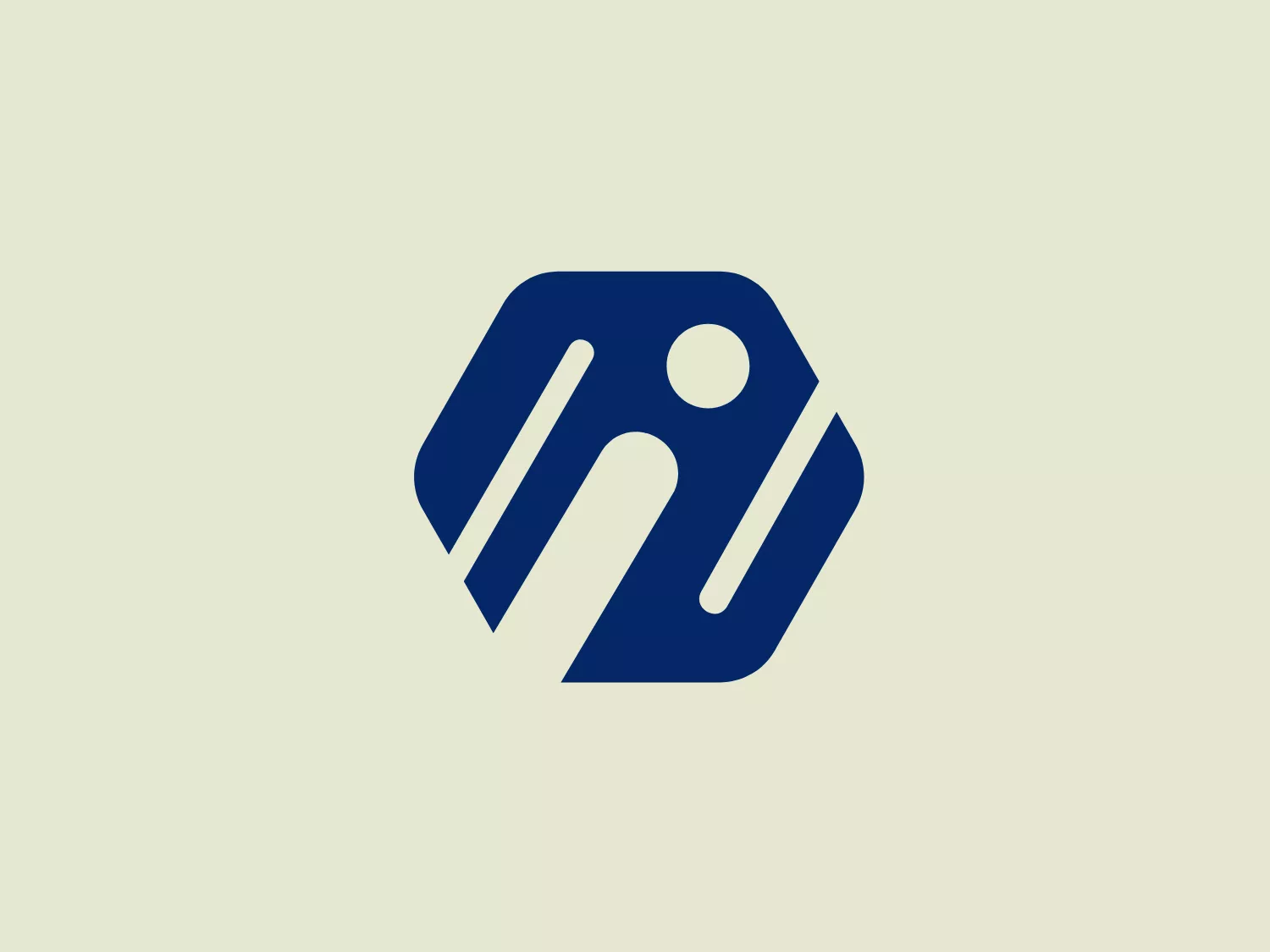 The Inigo logo is a modern, abstract design featuring dark blue elements. It includes a stylized hexagonal shape with rounded edges, diagonally bisected by a white line, creating a sense of division or motion. Inside the hexagon, there is a white circle that could be interpreted as a simplistic representation of a human head, with elongated shapes below it suggesting arms or motion lines. The overall aesthetic is minimalist and dynamic, conveying a sense of innovation or activity. Given the deep blue hue of the logo, a lighter background would complement it well.