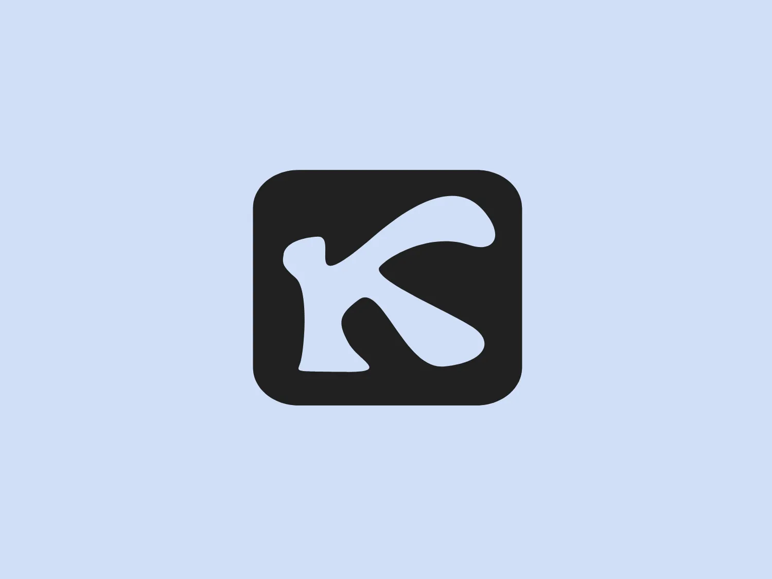 The logo in the image is a bold, stylized letter 'K' in white set against a vibrant red square background. The 'K' has a modern, dynamic design with a notch cut out on the upper right of the letter, giving it a distinctive look. The design aesthetic is clean, minimalist, and striking, with rounded corners on the square and a slightly slanted line in the 'K' conveying movement and a forward-thinking approach.