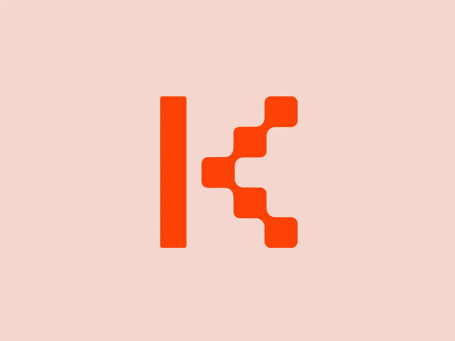 The Kodeco logo features a bold, geometric design consisting of two primary elements: a vertical bar and a stylized, stepladder-like shape that extends to the right. Both elements share the same vibrant orange color, creating a sense of unity and energy in the design. The overall aesthetic is modern and minimalistic, with clean lines and a lack of additional embellishments, which emphasizes the brand's forward-thinking and efficient qualities. The stepladder shape could suggest progress, connectivity, or technological innovation, depending on the context of the brand it represents.
