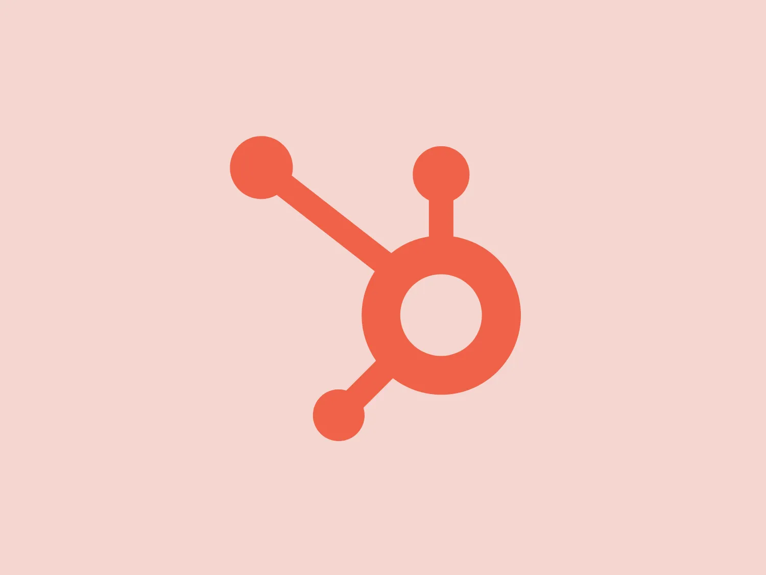 The logo features a stylized atom-like design, with a central circular nucleus and three electron orbits in different orientations. The minimalistic and abstract design conveys a sense of science, technology, or connectivity. The use of a soft, pastel orange color gives it a modern and friendly appearance, while a complementary background color would be a light, warm-toned shade such as a pale peach.