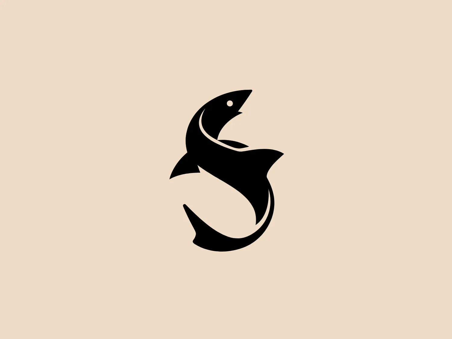 The Skittledog logo showcases a sleek, stylized black fish leaping upwards with a curved motion, featuring a single dot for an eye. The fish possesses a sharp dorsal fin and an elegant, flowing tail, which gives the design a dynamic and organic feel. The stark black contrasted against the white background creates a modern aesthetic with clean lines and a sense of movement. This minimalistic design makes it suitable for various modern businesses or brands related to aquatic life or themes of agility and grace.